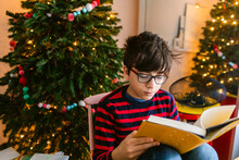 Boy Reading Book On Christmas Day