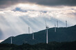 © Heng Yu/Stocksy - Rays Of Sunlight and Wind Turbine
