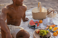 Crop Man Resting During Picnic On Beach