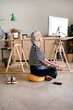 © Eloisa Ramos/Stocksy - Freelance woman doing meditation at cozy office