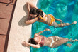 © Malquerida Studio/Stocksy - Women friends in a pool