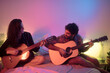 © Ibai Acevedo/Stocksy - Happy couple playing guitar together