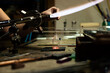© Albert Martinez/Stocksy - Glassblower working with torch flame and glass tube shaping
