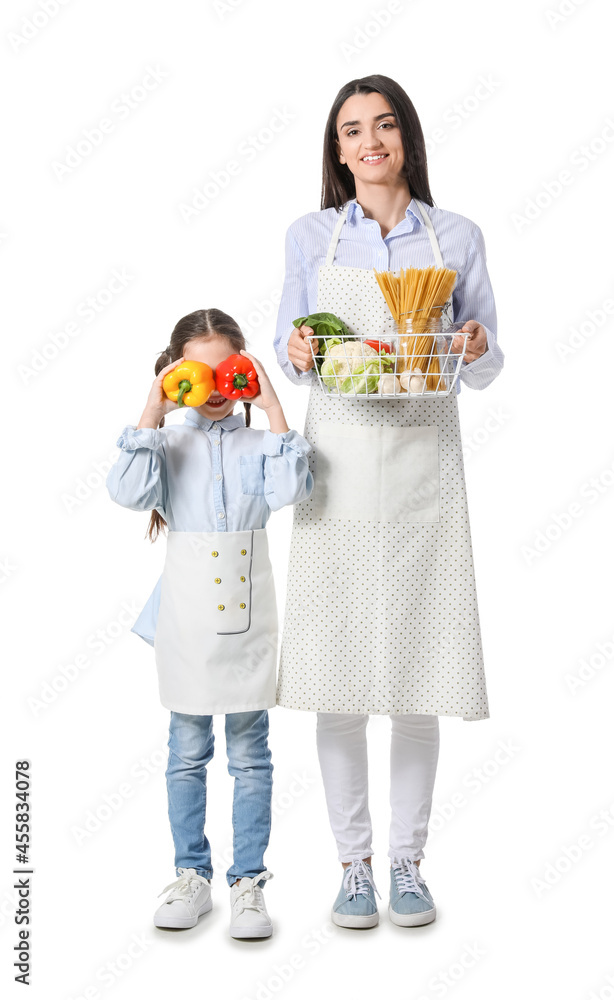 Young mother and daughter with fresh products on white background