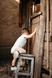 © Guille Faingold/Stocksy - Baby climbing on stool.
