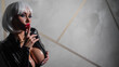 © Михаил Решетников - Sexy woman in a blonde wig and latex catsuit. Girl with big fake tits