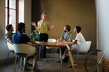 Poster - Casual business people meeting in circle in sunny office