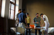 © KOTO - Casual business people meeting in circle in sunny office