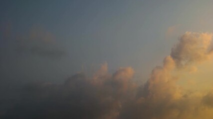 Wall Mural - timelapse of cumulonimbus clouds at dusk against blue sky background
