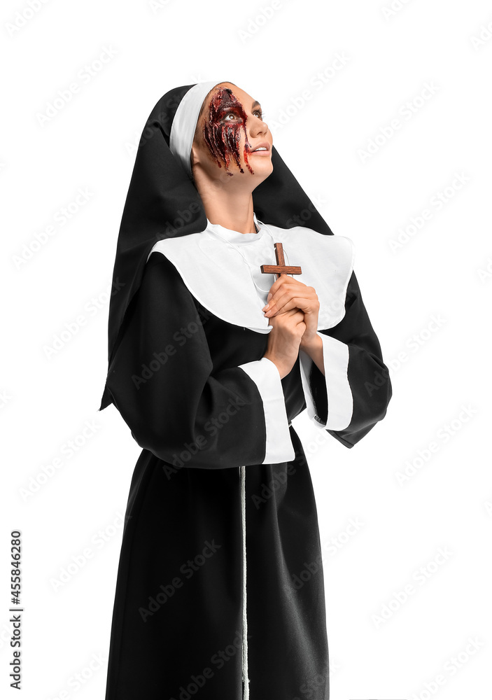 Woman dressed for Halloween as nun on white background