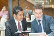 © KOTO - Businessmen using digital tablet in office