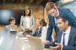 © KOTO - Businessmen using laptop in conference room