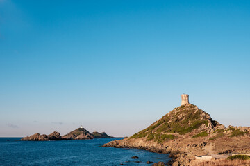 Wall Mural - The Genoese tower and lighthouse at Pointe de la Parata and Les Iles Sanguinaires near Ajaccio in Corsica under a deep blue sky