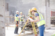 © KOTO - Engineer with clipboard using theodolite at construction site