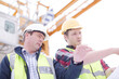 © KOTO - Construction worker engineer reviewing blueprints at highrise construction site
