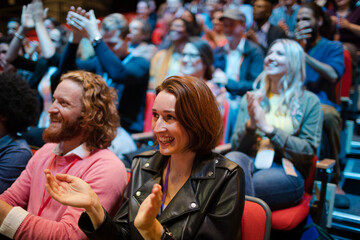 Smiling, excited audience cheering