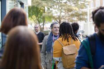 People talking outside auditorium