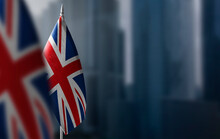 Small Flags Of United Kingdom On A Blurry Background Of The City