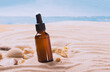 Glass bottle with essential oil serum cosmetic product background of seashells beach sand, product presentation 