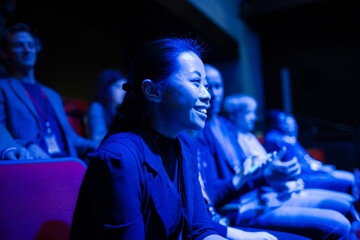 Smiling, enthusiastic woman cheering in audience