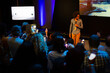 © KOTO - Male speaker with microphone talking to audience