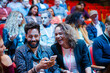 © KOTO - Man and woman with smart phone in conference audience