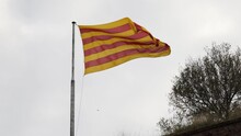 Catalan Flag At The Pole Flies In The Wind At Cloudy Sky Background On Cold Weather.