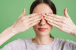 © Drobot Dean - Young brunette woman covering her eyes while posing on camera