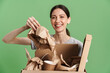 © Drobot Dean - Young brunette woman smiling while posing with paper waste