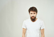 © SHOTPRIME STUDIO - emotional man in a white t-shirt hand gestures anger close-up