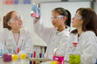 © KOTO - Girl students conducting scientific experiment in laboratory classroom