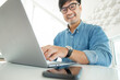 © panitan - asian man work using computer hand typing laptop keyboard contact us.student study learning education online.adult professional people chatting search at office.concept for technology device business