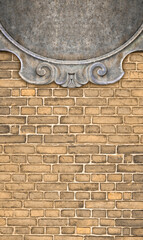 Wall Mural - Detail of an old classic carved stone frame against a brick wall - concept with copy space