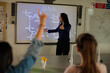 © KOTO - Female science teacher teaching DNA lesson at projection screen
