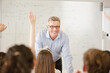 © KOTO - Male teacher leading lesson at whiteboard in classroom