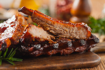 Wall Mural - Roasted pork ribs in a bbq sauce. Served on a wooden board. Front view.