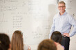 © KOTO - Male teacher leading lesson at whiteboard in classroom