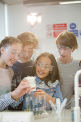 Wall Mural - curious, smiling students watching chemical reaction, conducting scientific experiment in laboratory
