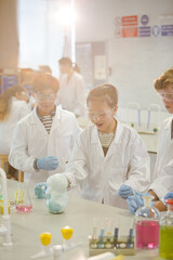 Wall Mural - surprised students conducting scientific experiment, watching chemical reaction in classroom laborat