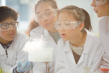 Wall Mural - surprised, curious students watching chemical reaction, conducting scientific experiment in laborato