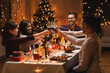 © Syda Productions - holidays, party and celebration concept - multiethnic group of happy friends having christmas dinner at home and drinking wine