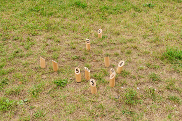 Wooden sticks with numbers on the ground for a game