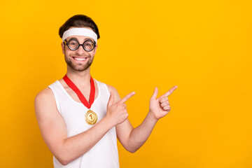 Poster - Portrait of handsome cheerful guy nerd sportsman showing copy empty space ad isolated over bright yellow color background