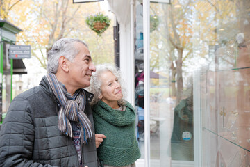 Wall Mural - Senior couple window shopping at storefront