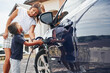 © standret - Charging the car. Woman with little boy near the the modern automobile at daytime