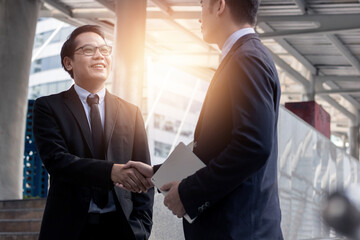 Wall Mural - Successful negotiate and achievement concept, two business people shake hand after talk and success in investment deal