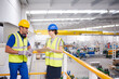 © KOTO - Supervisor and worker with clipboard talking in factory