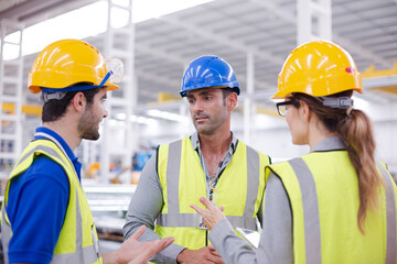 Wall Mural - Supervisor and workers talking in steel factory