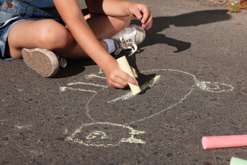 Canvas Print - Little child drawing cat with colorful chalk on asphalt, closeup