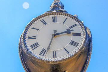 Wall Mural - Metal dial and chairs of a street clock in the park